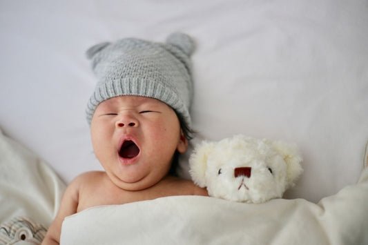 baby yawning in bed after drinking chamomile for babies