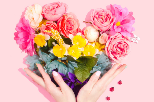 hands holding flowers in shape of a heart